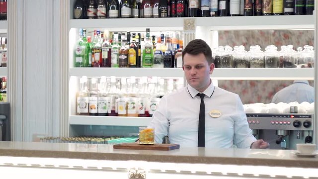 Bartender serves manhattan twist cocktail 1