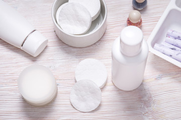 Fototapeta na wymiar Set of plastic bottles for cream or face lotion on wooden table