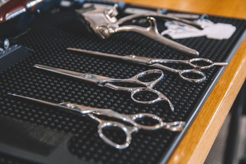 Fototapeta na wymiar Stylish professional barber scissors. Hairdresser salon concept, hairdressing tool set