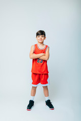 Portrait of smiling boy with basketball on studio