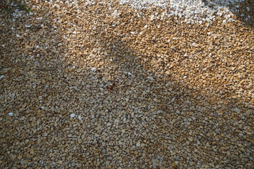 Brown and White pebble stone texture for background. The texture of brown gravel stones.