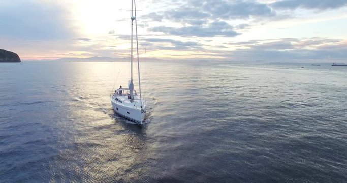 Aerial view of bautiful white sailing yacht in the Eastern Bosphorus strait at sunset. Vladivostok