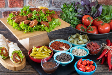 Cig kofte (raw meatball in Turkish) with lettuce, tomato, pickle and lemon, hot Chee kofta
