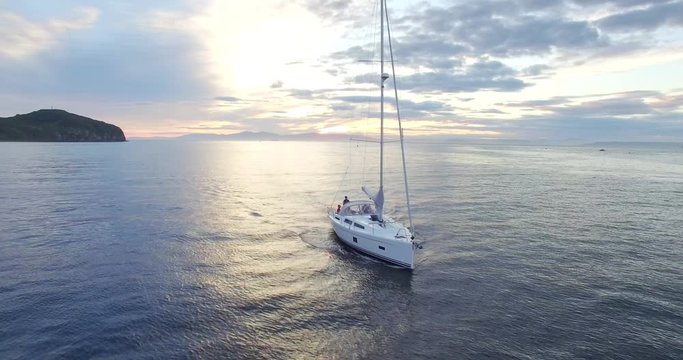 Aerial view of bautiful white sailing yacht in the Eastern Bosphorus strait at summer sunset. Vladivostok