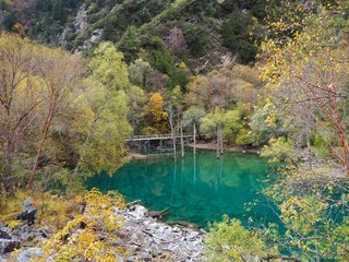Fototapeta premium Blue lake and colorful forest of plateau in Songpinggou Scenic Area, Sichuan Province, China