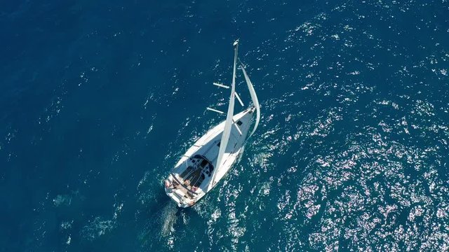 Aerial view. Sailing yachts with white sails in the open Sea.