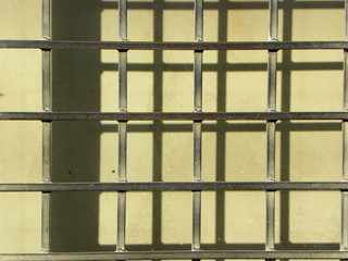 iron grate on a gray wall background