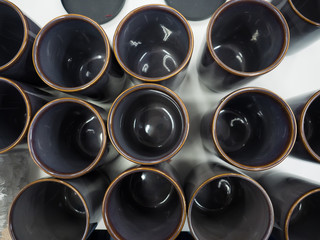 Cups, top down view of many brown mugs in a factory or shop