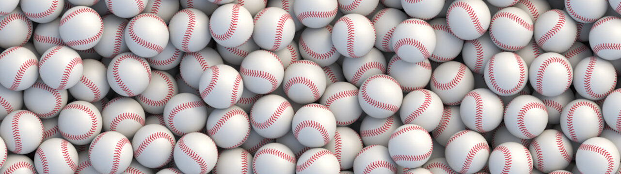Baseball balls background with red stitching lying in a pile
