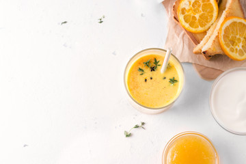 Lassi breakfast with mango and sandwich. Next to a white background are the ingredients of yogurt and jam. top view. Have copy space