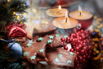 Fototapeta na wymiar Christmas and New Year celebration, homemade gingerbread cookies and decorating with candles on festive table