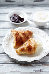 Croissant with coffee and jam. White wooden background. 