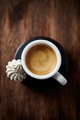 Cup of coffee on rustic wooden background. Top view. Close up.