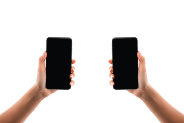 cropped view of woman holding smartphones isolated on white