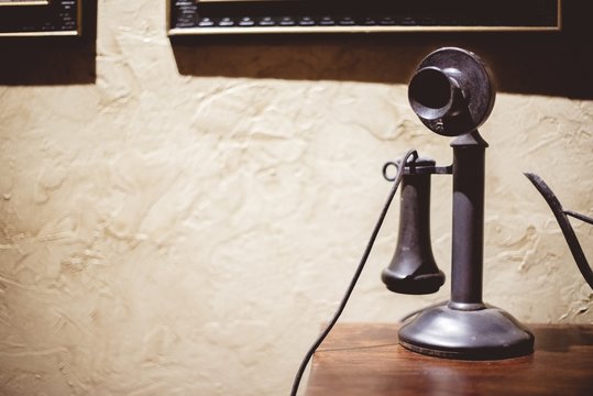 Vintage telephone on a wooden surface