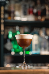 Espresso vodka cocktail on a bar desk.