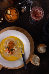 Lunch Chicken soup with croutons and chicken breast salad and wine on a dark 