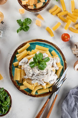 Pasta with mushroom sauce and basil and hard cheese