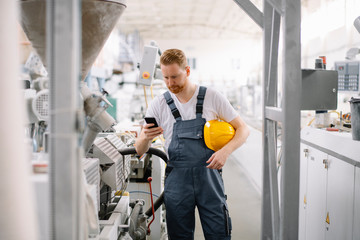 Factory worker with phone.