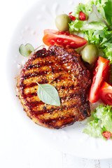 Grilled pork steak with fresh salad. Top view. 