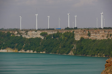 Rocky beach. Wind generators. Green electricity.  Black Sea. Cape Kaliakra, Bulgaria.