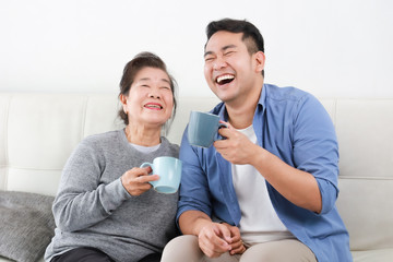 Asian senior grand mother and son drinking coffee and talking happy and smile face in living room - 309179168