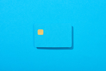 top view of colorful empty credit card on blue background