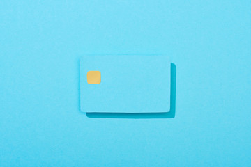 top view of colorful empty credit card on light blue background