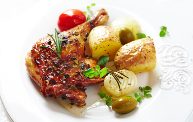 Roast duck leg with oven baked potatoes and fresh rosemary. Christmas meal concept. White background. 