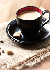 Cup of coffee on rustic background. 