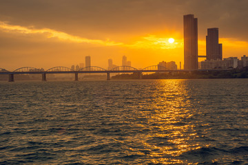 Sunset through the clouds over Han River Dongjak bridge.