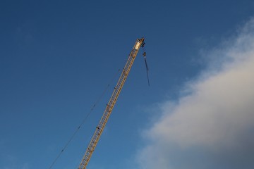 Yellow crane in the wind on blue sky background