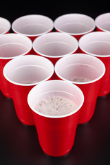 The arrangement of red plastic cups for game of beer pong