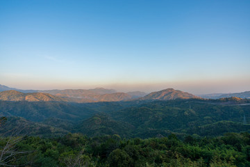 Fototapeta na wymiar beautiful blue sky high peak mountains mist fog wildlife green forest at Khao Koh Phu Tub Berk Phetchabun Thailand guiding idea long weekend for backpacker camping campfire relaxing hiking 