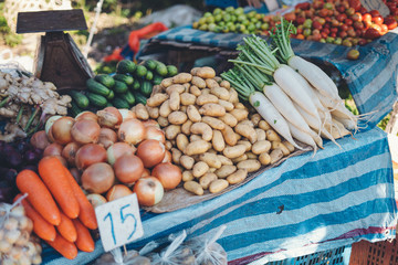 vegetables and potatoes are on sale in the fresh market