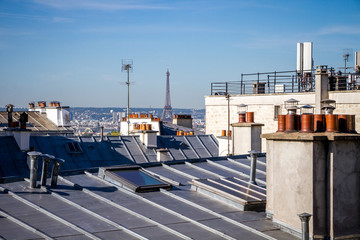 The traditional roofs of paris and the eiffel tower