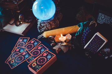 Tarot cards and crystal ball, candles, witch magic bottles . Wicca, esoteric, divination and occult...