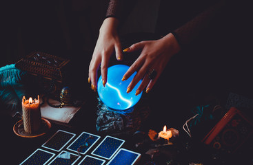 Tarot cards and crystal ball, candles, witch magic bottles . Wicca, esoteric, divination and occult...
