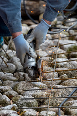 Metal worker cutting steel with a radial saw