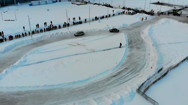 Aerial shot of winter drift competition on Russian Classics Lada VAZ-2107. Taken by drone