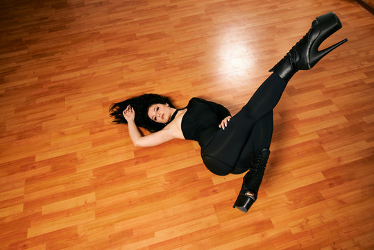 Attractive girl with a good figure dancing strip-plastic in the dance class. Strip-dance. Frame up strip. Sport.