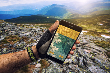 Smartphone GPS navigator in man's hand.