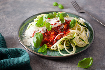 keto paleo zoodles bolognese: zucchini noodles with meat sauce and parmesan