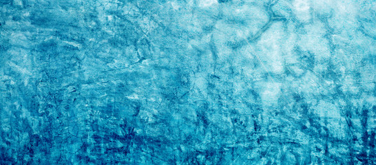 The background of the stucco wall is blue. Abstract grunge decorative plaster wall. Rough surface with light blue cyan pattern, copy area for design