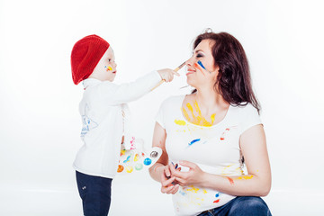 mother and little boy paints when painted