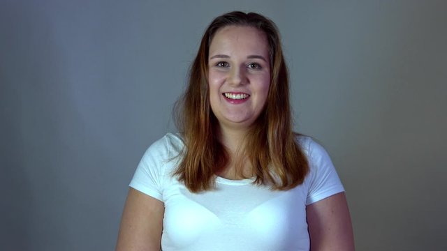 Portrait of chubby and body positive woman in casual tshirt with smiling expression.