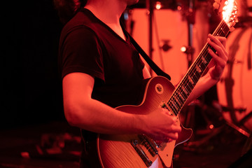 Man playing guitar on the stage at the concert
