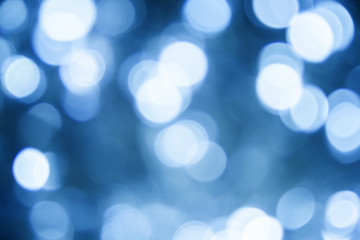 Fototapeta premium Blurred christmas lights classic blue background. Abstract bokeh with soft light. Shiny festive texture