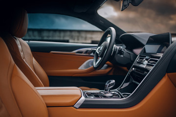 Modern supercar interior with leather panel, multimedia and dashboard