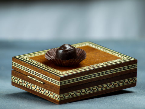 chocolate bonbon on a wooden box